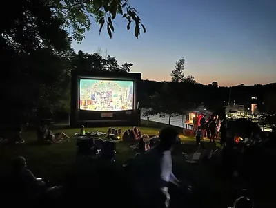 Outdoor movie night with families gathered on blankets